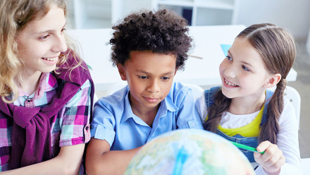 children with teaher and globe.jpg