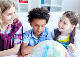 children with teaher and globe.jpg